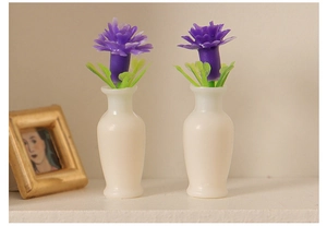 Macro detail of miniature dollhouse vases with purple flowers and golden frame decor