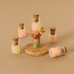 Miniature dollhouse candy glass jars on a realistic tree stump display stand