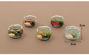 Detail view of miniature dollhouse fish tanks with colorful fish and green plants