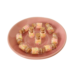 Set of 11 miniature glass jars with colorful beads and cork lids for dollhouse decor