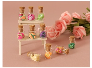 Miniature glass jars with colorful fruit slices and cork stoppers for dollhouse decor