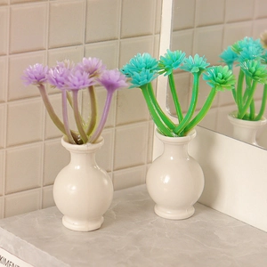 Miniature dollhouse flower pots with purple and green daisies in white spherical vases