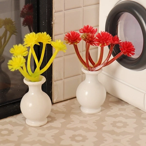 Miniature dollhouse potted plants with yellow and red flowers in white ceramic vases