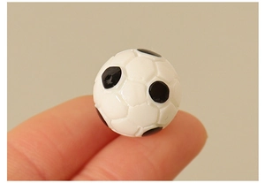 Macro shot of a tiny miniature soccer ball accessory for DIY dollhouse decoration