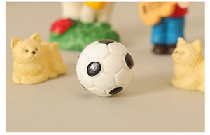 Macro view of miniature football dollhouse decoration with realistic stitching and textures