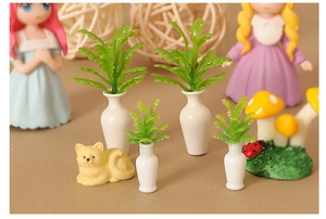 Detailed macro view of miniature dollhouse ceramic vases with green artificial plants