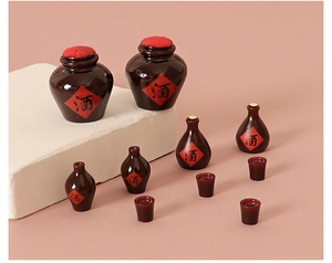 Detailed close-up of miniature vintage brown resin wine bottles with red labels