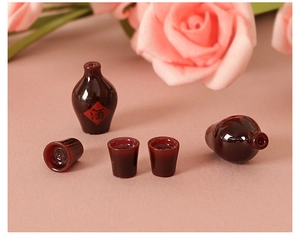 Macro shot of miniature red resin wine jars and cups for DIY crafts and decor