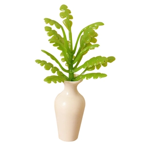 Miniature dollhouse plant in a white ceramic vase for creative desktop decoration