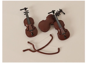 Detailed macro view of miniature violins with bows for dollhouse music room decor