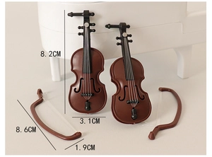 Detailed macro view of 8.2cm miniature violin set for dollhouse decor with bow