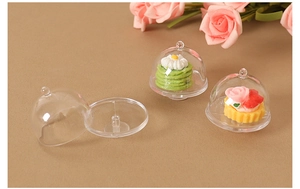 Detailed view of mini transparent display cloches with simulated desserts for dollhouse decor