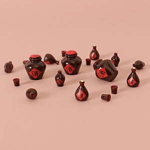 Miniature vintage Chinese wine jars and bottles on a pink background for DIY crafts