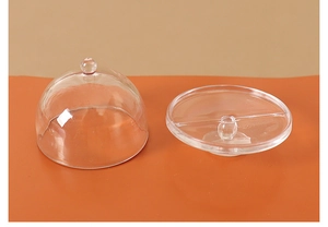 Macro shot of miniature clear food dome cover and matching round display base tray