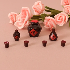 Miniature resin wine bottle set for dollhouse decor featuring red ceramic glaze style