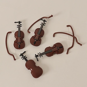 Miniature violin set for dollhouse decor featuring realistic wood grain and black bows