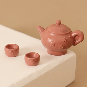 Miniature dollhouse reddish-brown clay tea set with teapot and two embossed cups