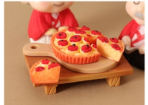 Detailed macro view of a miniature dollhouse cherry tart on a tiny wooden board