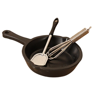 Miniature kitchen playset with a black frying pan, spatula, and whisk for dollhouse decor