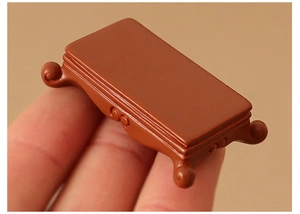 Miniature Chinese dollhouse altar table in resin held by hand to show tiny scale
