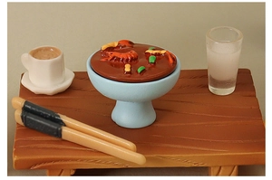 Detailed view of miniature dollhouse hotpot set with tiny food, bowls, and chopsticks