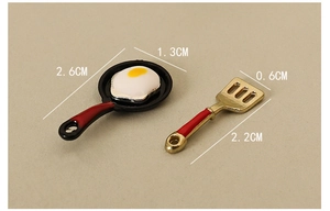 Miniature kitchen dollhouse set with fried egg pan and spatula, red handle detail