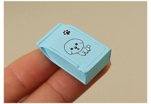 Miniature blue dollhouse pet food bag model featuring a cute black cartoon dog pattern