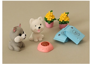 Detailed macro view of 7-piece dollhouse miniature puppy figurine and food accessories set