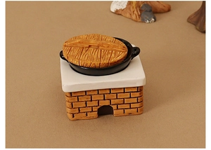 Miniature dollhouse kitchen stove model with red brick texture and wooden lid detail