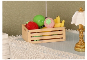 Detailed view of dollhouse miniature wooden fruit basket with resin strawberries and apples