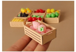 Miniature dollhouse wooden fruit crate with tiny resin strawberries shown held in hand
