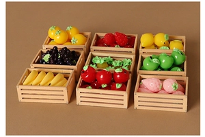 Detailed macro view of various resin miniature fruits in small wooden dollhouse crates
