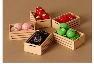 Macro detail of dollhouse miniature fruit baskets with resin apples and grapes