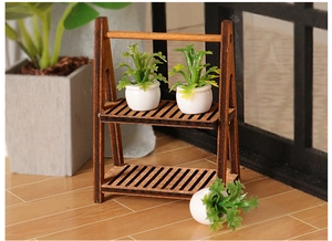 Miniature two-tier wooden plant stand with small green potted plants for dollhouses