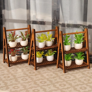Three tiered wooden miniature plant stands with colorful dollhouse potted plants