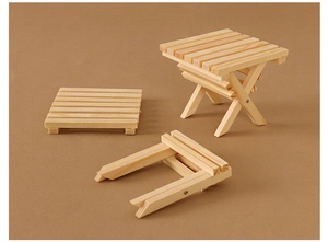 Detailed view of dollhouse mini wooden folding table with visible natural grain textures