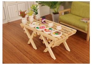 Detailed dollhouse scene with miniature folding wooden table and tiny breakfast accessories