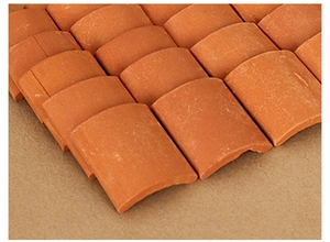 Macro view of miniature orange clay roof tiles for DIY dollhouse and scale model scenery