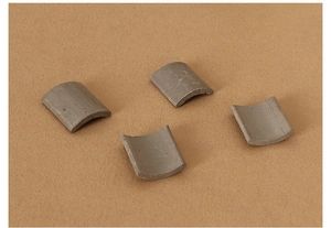 Detailed view of four miniature grey clay roof tiles for dollhouse building models