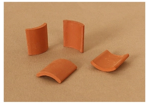 Detailed view of four curved terracotta clay roof tiles for miniature dollhouse modeling