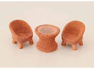 Close-up of miniature 1:12 scale dollhouse table and chairs with realistic brown rattan texture