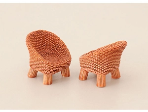 Detailed view of miniature dollhouse chairs with intricate brown woven texture design