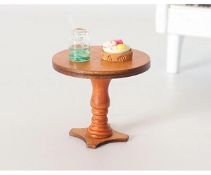 Macro view of miniature dollhouse round wooden table with vintage carved leg and food props