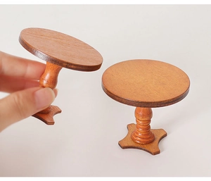 Detailed macro view of two miniature round wooden tables for dollhouse decor with wood grain