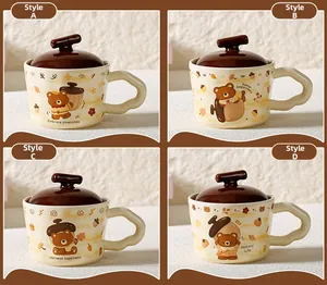 Detail of four ceramic bear mugs with autumn patterns, lids, and wavy handles