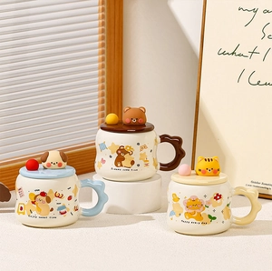 Detail of cute ceramic mugs with 3D animal lids and unique wavy handles in warm lighting