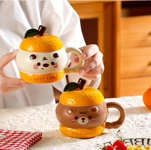 Detail of creative ceramic mugs with 3D orange lids and cute cartoon bear face design