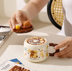 Detailed view of ceramic mug featuring a 3D bear lid and cartoon character design