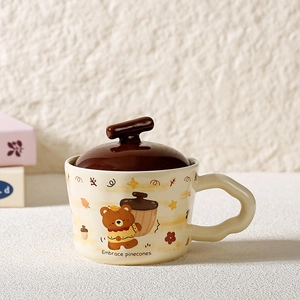Detailed view of ceramic bear mug featuring a unique wavy handle and a dark brown lid