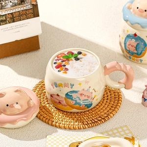 Close-up of cute cartoon pig ceramic mug with a 3D donut lid and wavy pink handle